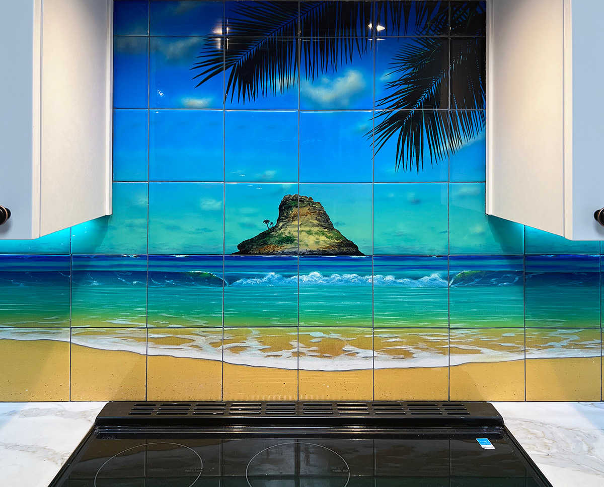 Detail of a Kitchen tile mural Backsplash featuring a view of Chinaman's Hat from a beach on Oahu's windward coast.